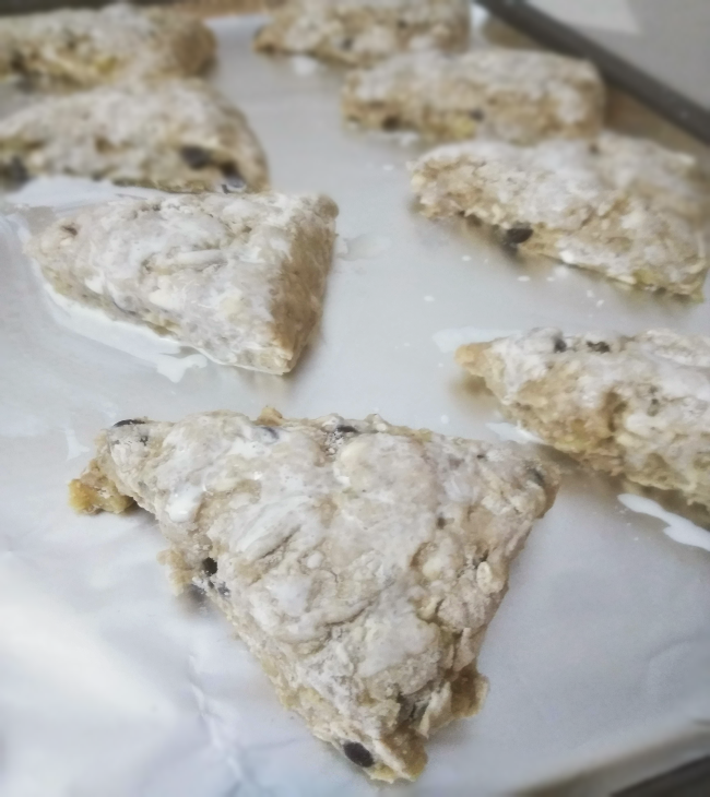 raw banana nut scones cut into triangles on baking sheet