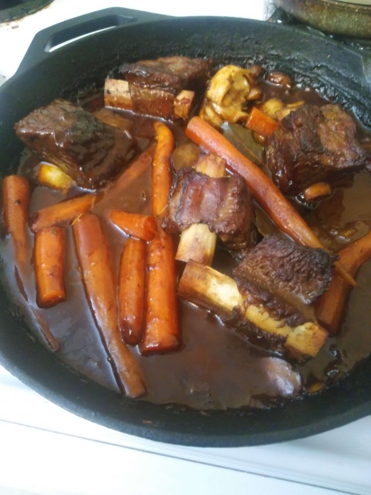 seared beef short ribs in red wine reductions with carrots