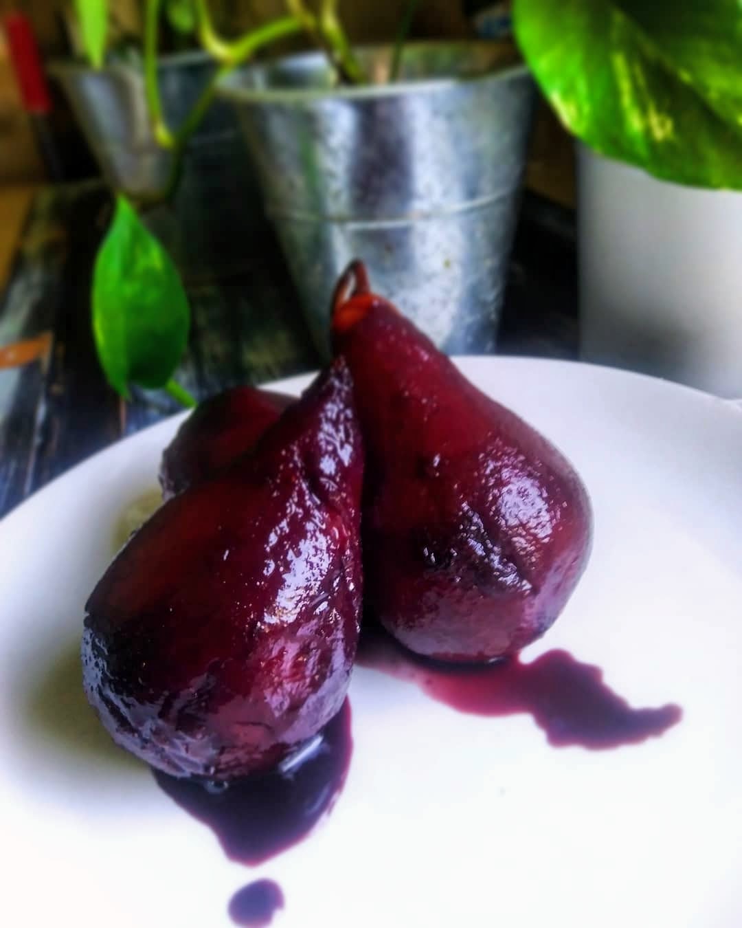 red wine poached pears on white plate