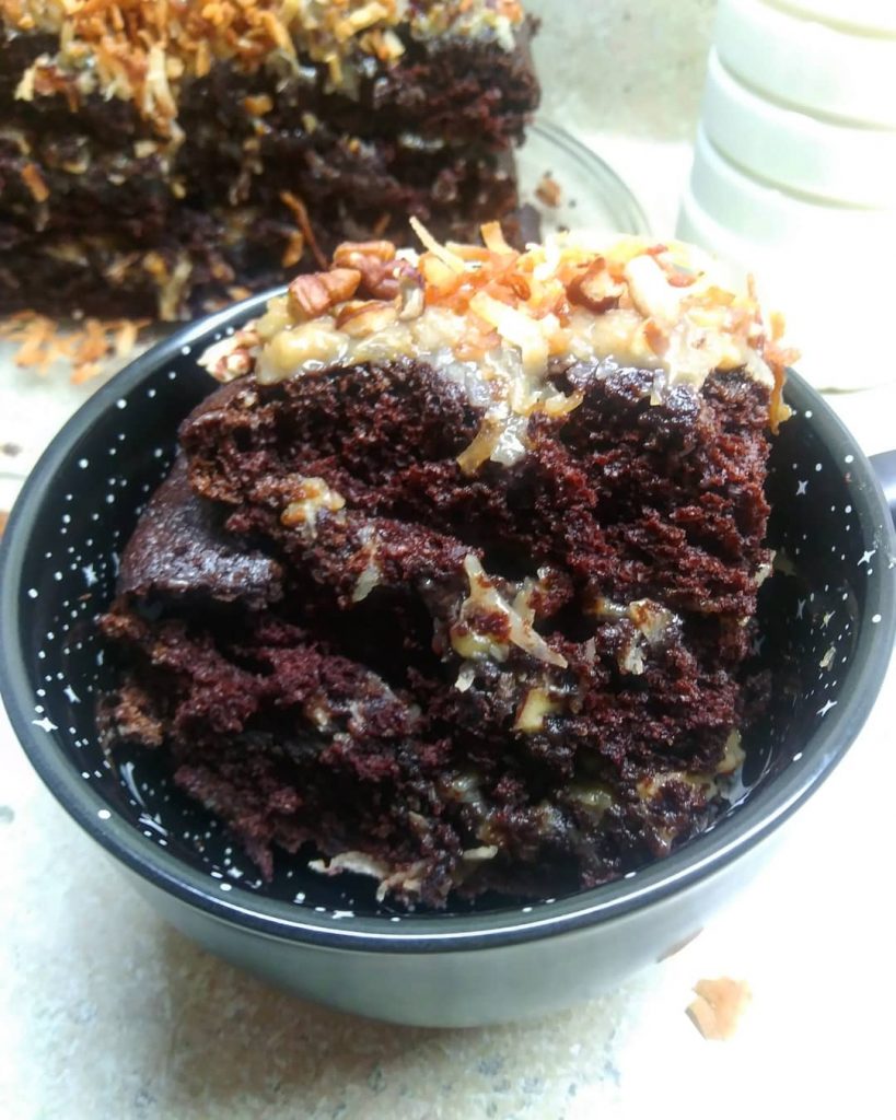german chocolate cake in black cup with white stars and dots