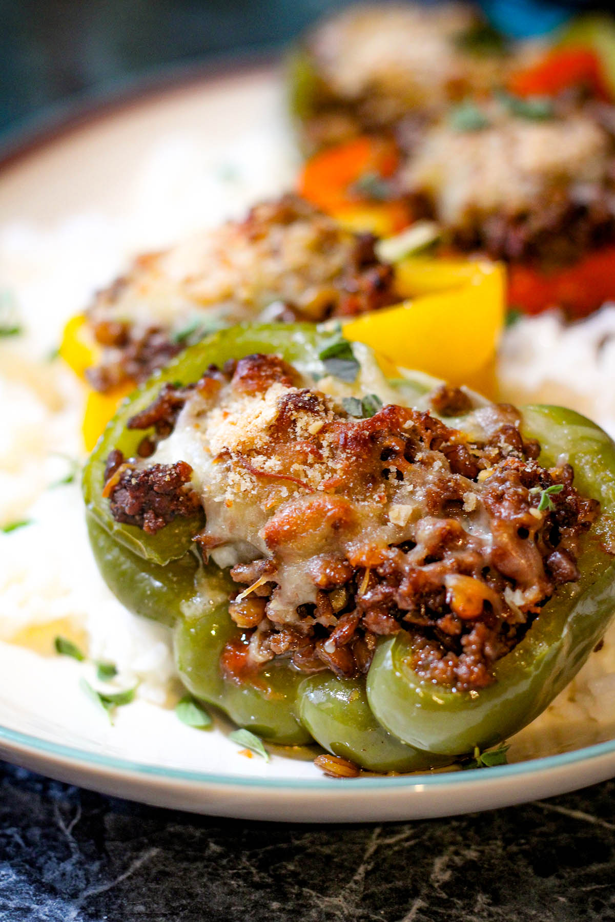 4 lentil and sausage stuffed peppers with melted cheese.