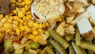 Slow cooker filled with ingredients for soup recipe.