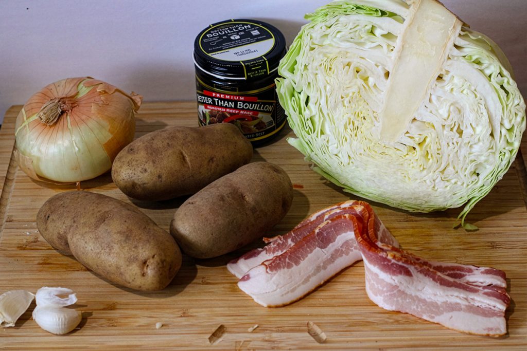 Ingredients for side dish recipe: onion, potatoes, cabbage, bacon, garlic, and Better than Bouillon beef base.